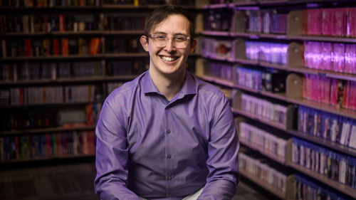 A photo of Clayton Zimmerman sitting in the Computer and Video Game Archive