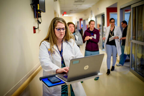 doctor typing on laptop
