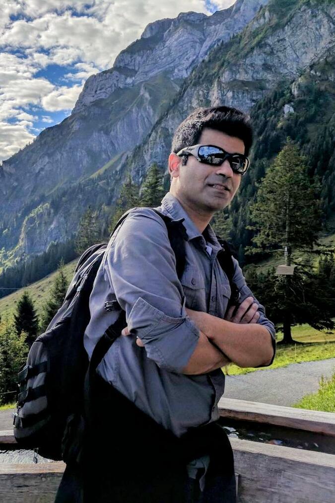 Khurram Abbas posing in front of a mountain