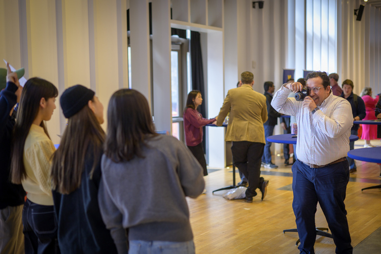 Students mingle in space 2435, a large event space