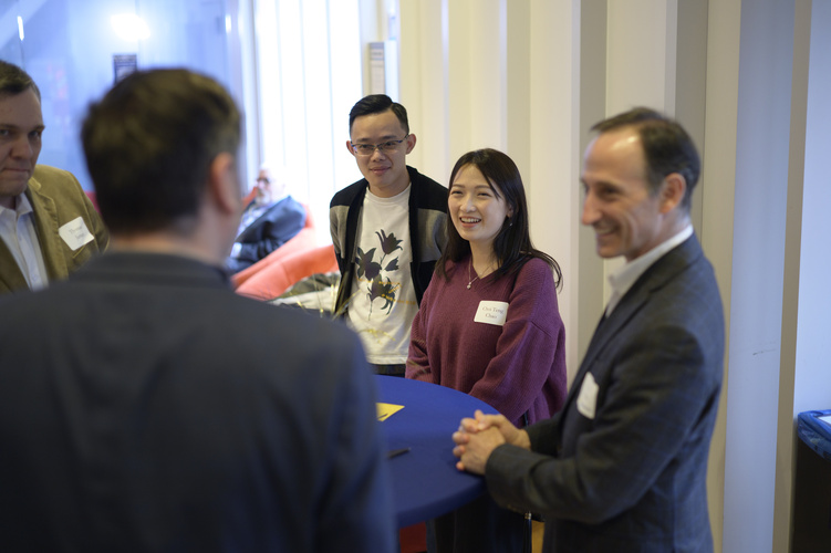 Students mingle in space 2435, a large event space