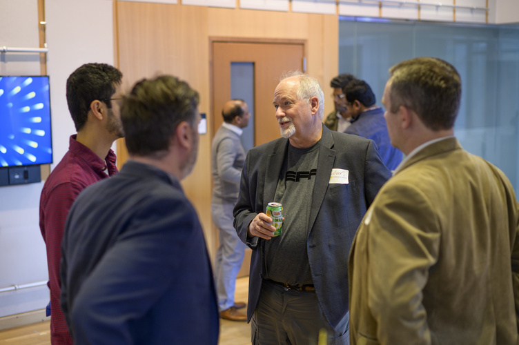 Students mingle in space 2435, a large event space