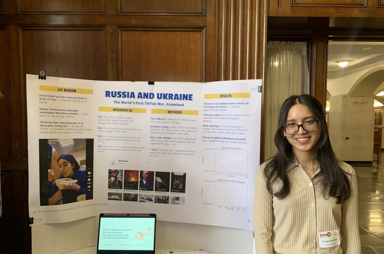 UMSI student Pratiksha Badola poses with the poster board for their project at the 2023 UMSI Student Project Exposition. The project board is titled “Russia and Ukraine: The World’s First TikTok War, Examined.” 