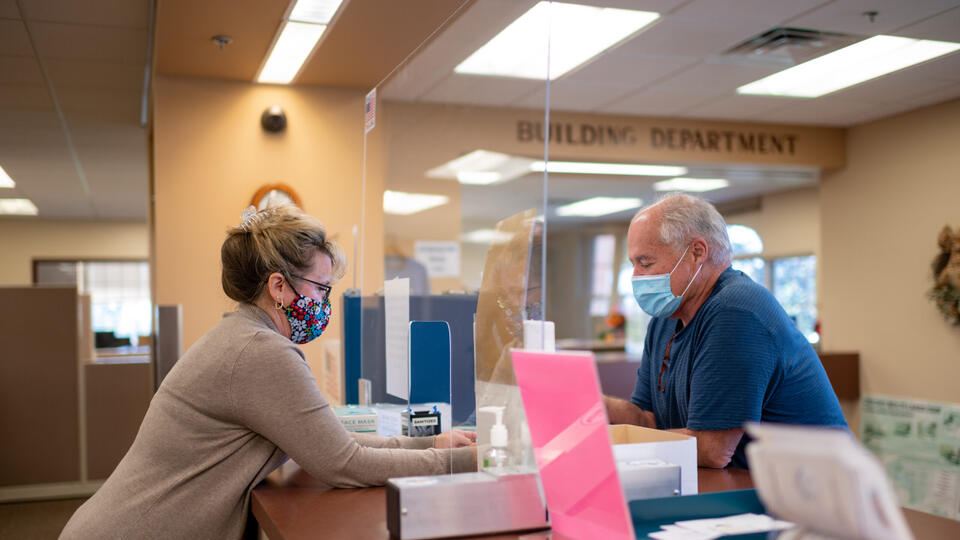 Kelly Richter, the clerk’s office administrative assistant in Oxford Township, assists a resident at the public counter.
