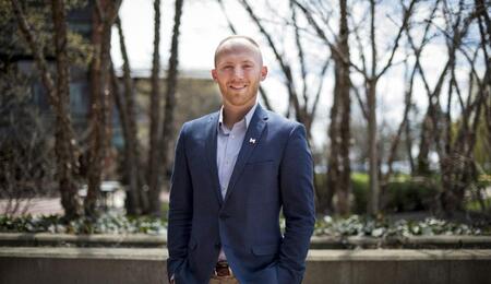 Dane Jacobsen standing outside on campus and smiling.