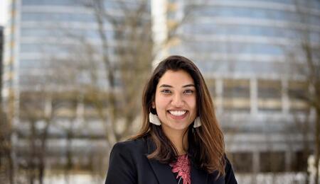 Veena Panicker standing outside on the medical campus and smiling.
