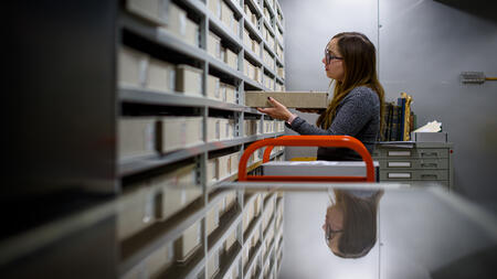 Allison Thorsen shelving a box in an archive