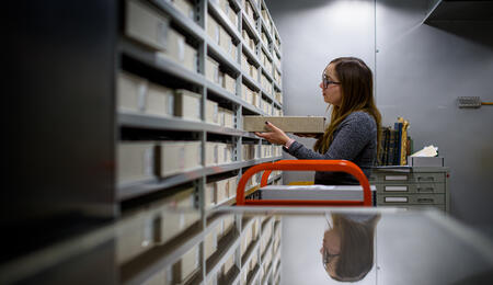 Allison Thorsen shelving a box in an archive