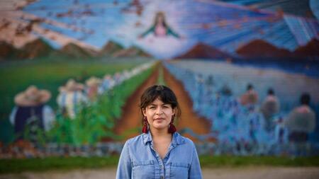 Sylvia Darling standing in front of a mural in Detroit. 