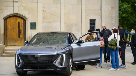 UMSI automotive UX students standing outside of a car. 