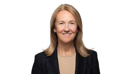 A professional headshot of Stephanie Teasley wearing a black blazer and smiling at the camera. She has blonde hair. 