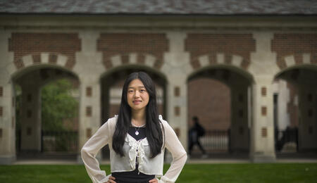 Allison He stands outside of North Quad, posing with her hands on her hips