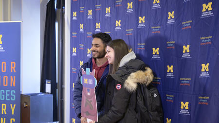 Students pose with a Mumsi cutout at the 2023 Giving Blueday celebration
