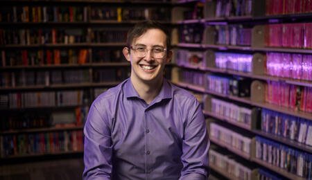 A photo of Clayton Zimmerman sitting in the Computer and Video Game Archive