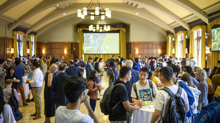 Students networking in a ballroom.