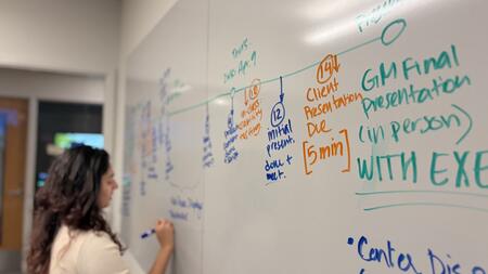 Dhruvi Jagani writes on a whiteboard