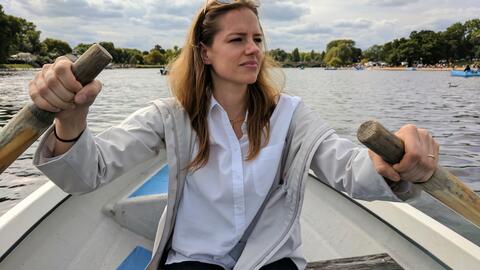 Stacey Beck canoeing and looking into the distance