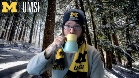 An example photo of a person in front a UMSI seasonal background