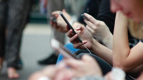 A group of people looking at their smartphones 