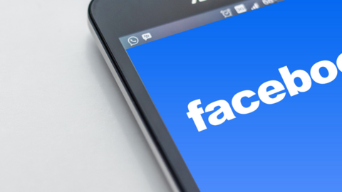 A corner of a smartphone with facebook on the screen