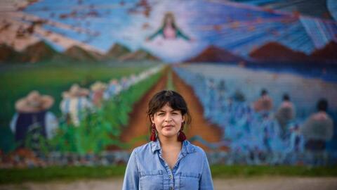 Sylvia Darling standing in front of a mural in Detroit. 