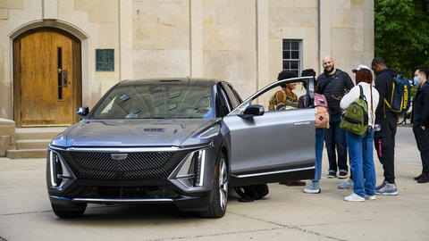 UMSI automotive UX students standing outside of a car. 