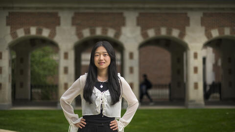 Allison He stands outside of North Quad, posing with her hands on her hips 
