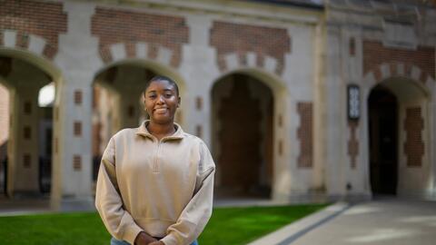 A photo of Tyra Briscoe standing outside of North Quad. 