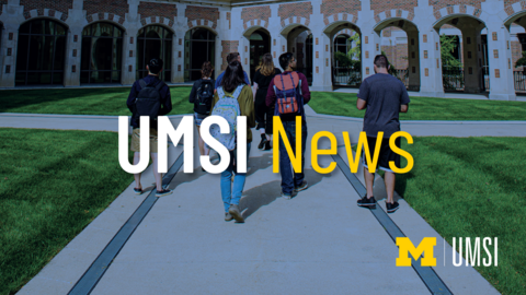 UMSI News. Students walking towards a building. 