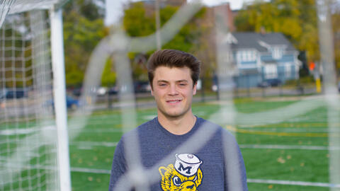 Benjamin Riela stands near a soccer net on the U-M campus.