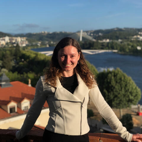 Gabriela Marcu poses with a view of a river behind her