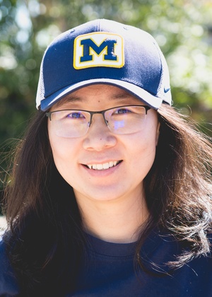 A headshot of Kaiwen Sun wearing a University of Michigan hat