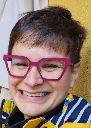A headshot of Angela Schöpke Gonzalez