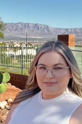 A headshot of Cassidy Pyle with a mountain in the background.