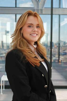 A headshot of Jess Cummings in a blazer