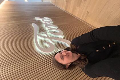 A student taking a selfie in front of an illuminated Ford sign