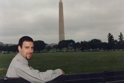 A student sitting on a bench near the Washington Monument in D.C.