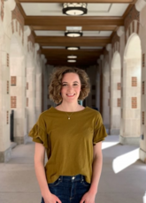 Bridget Doherty stands in a courtyard with pillars